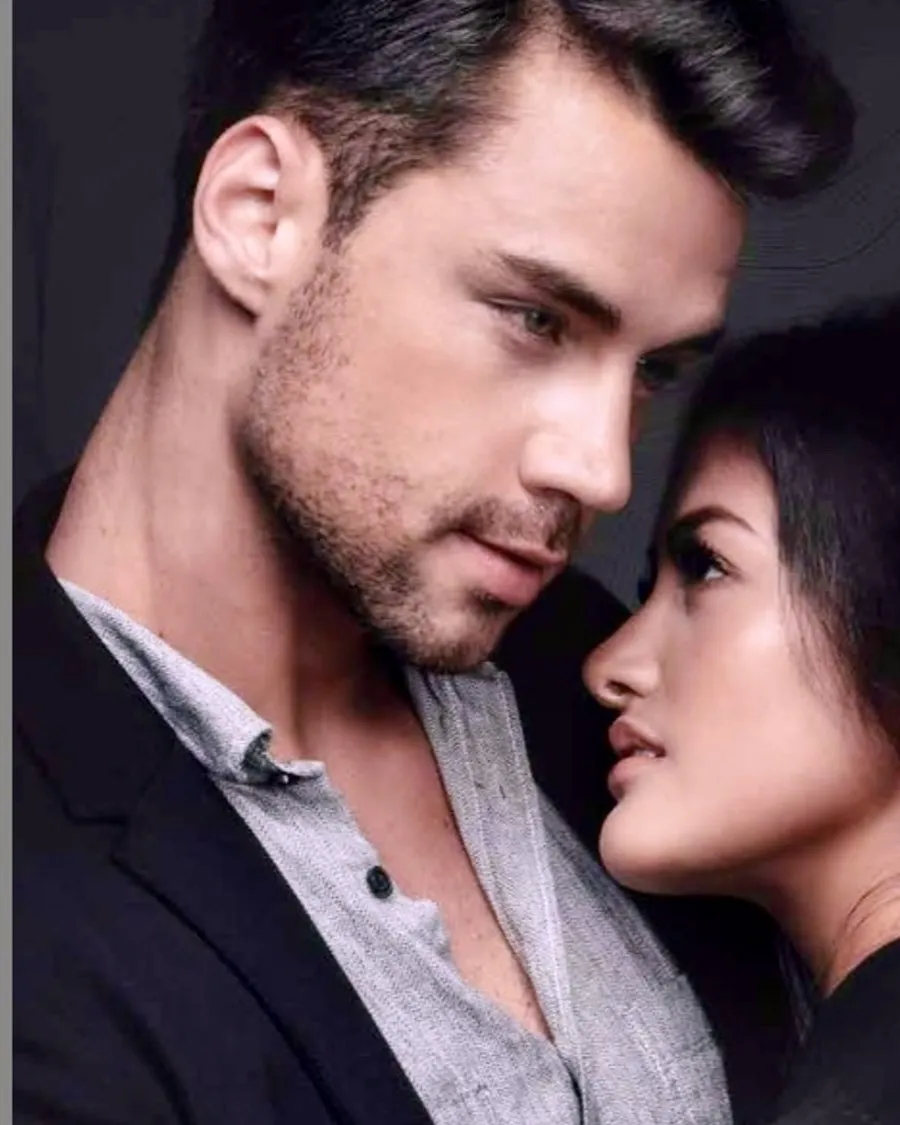 Confident HEADS client with a full, natural hair system, with his partner