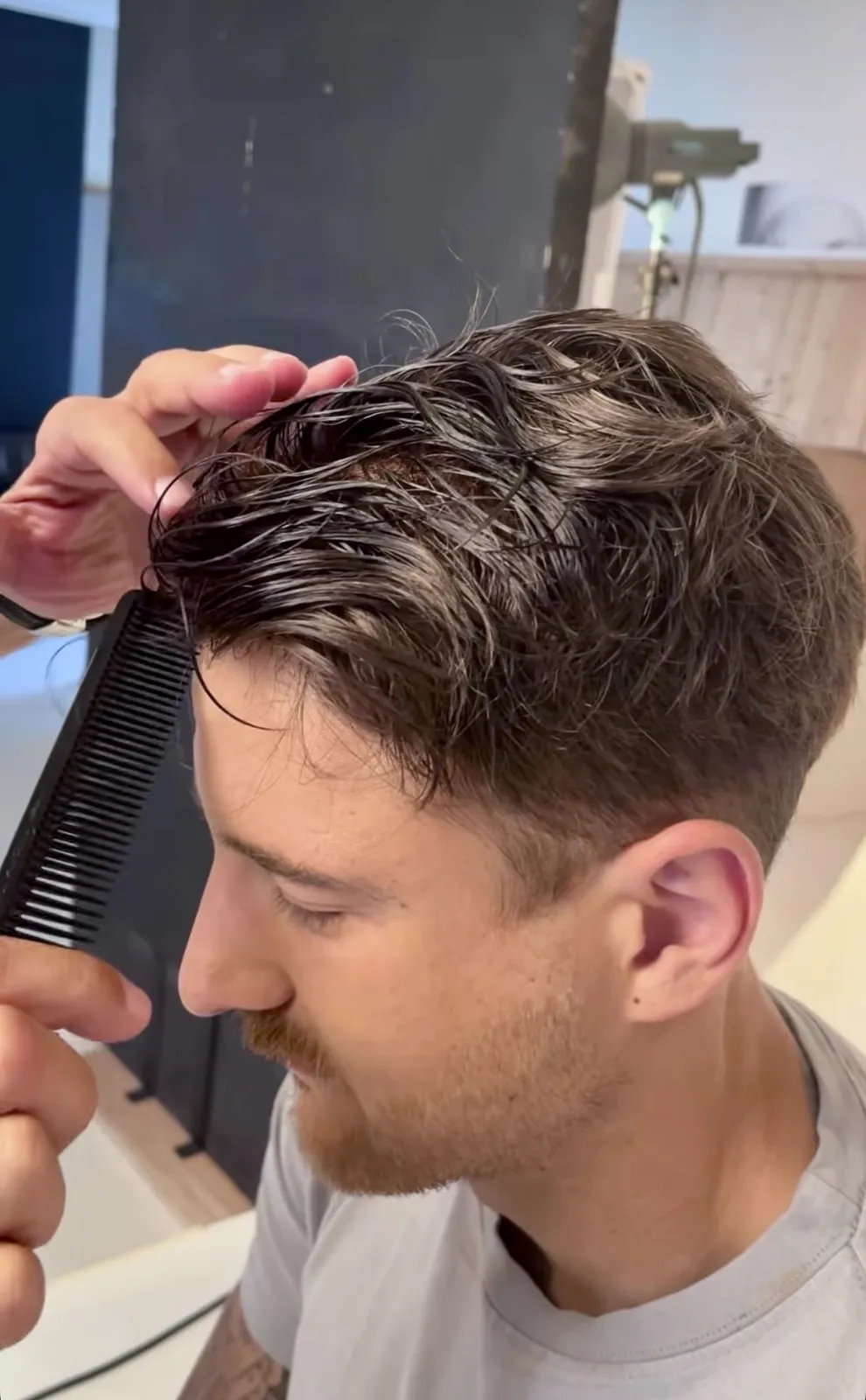 HEADS stylist styling the natural hairline of a men's hair system